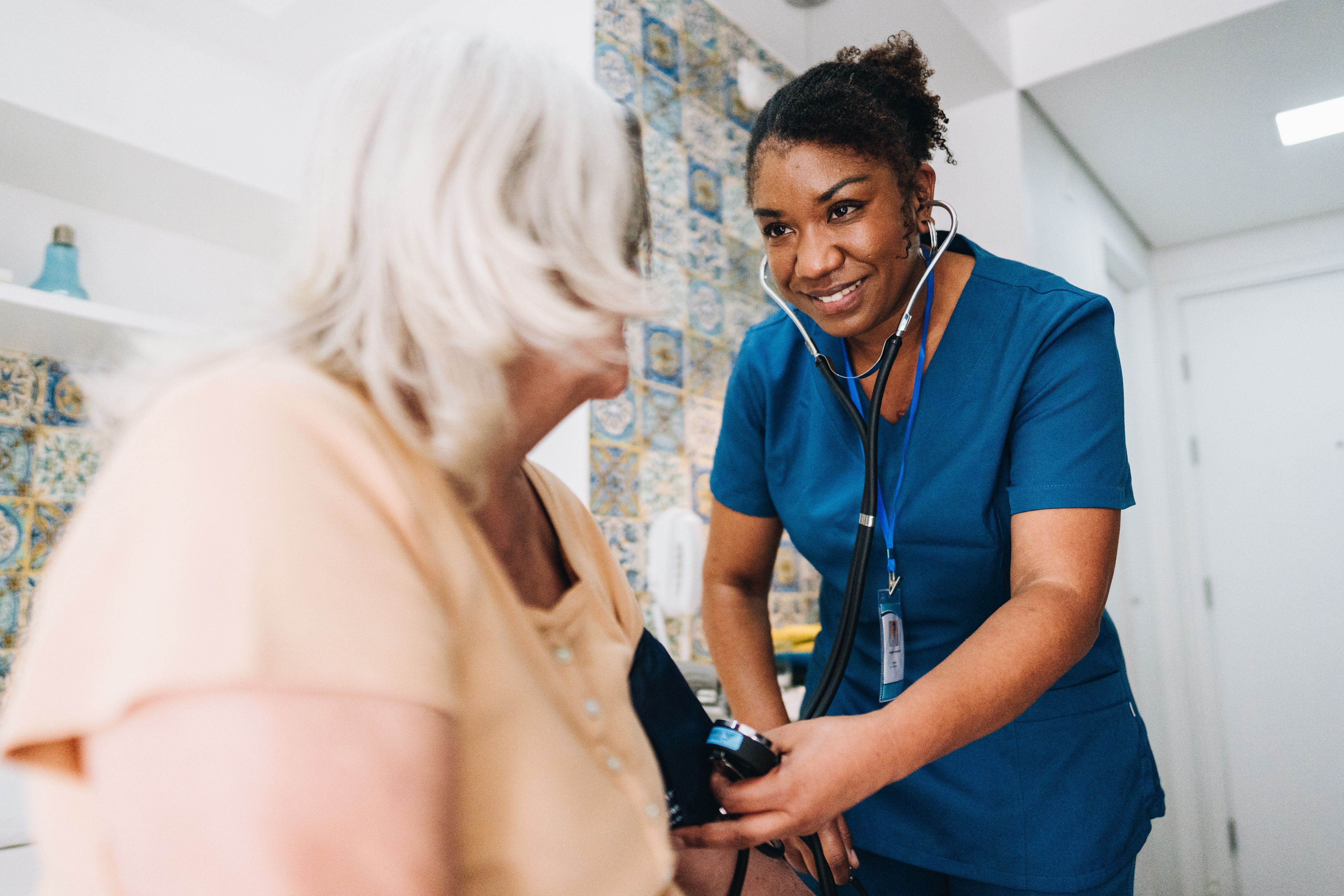 A radiologic technologist positioning a patient for a CT scan